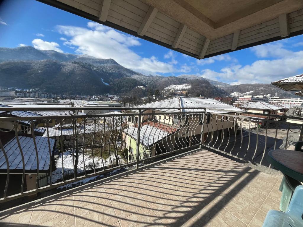 a balcony with a view of a city and mountains at Grand Panorama Apartment in Fojnica