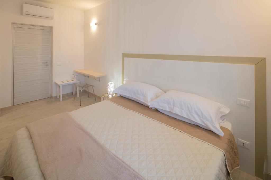 A bed or beds in a room at Affittacamere Margherita