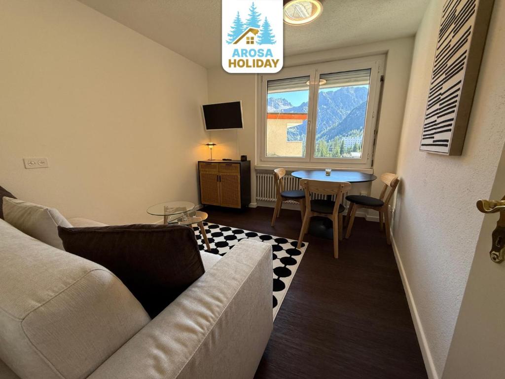 a living room with a couch and a table at Jäggi 35 by Arosa Holiday in Arosa