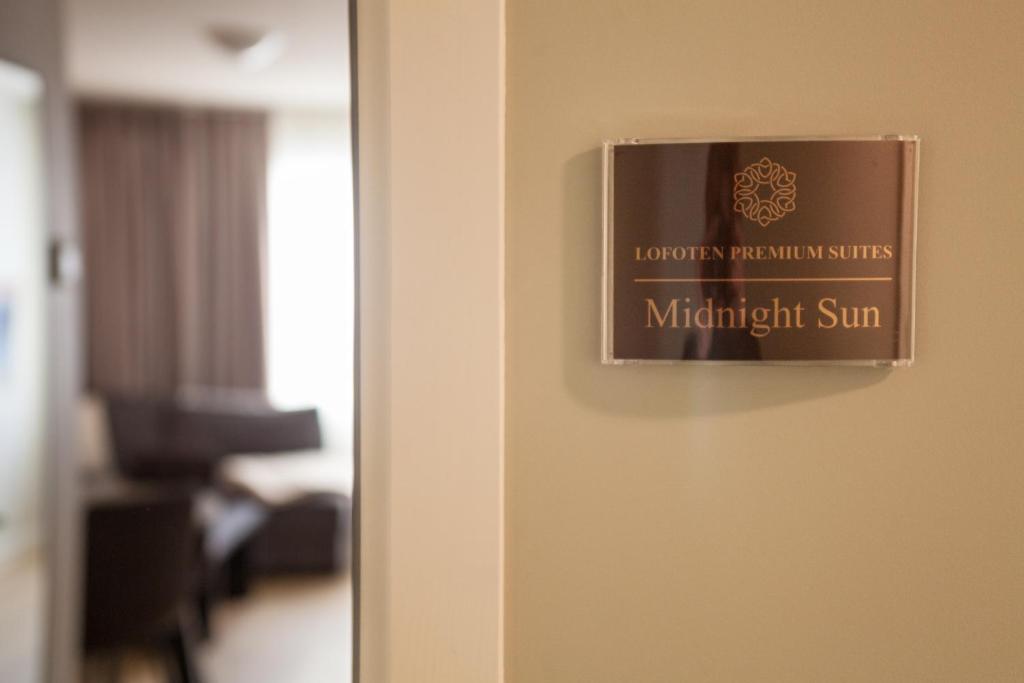 a sign on a door in a hotel room at Lofoten Premium Suites in Leknes