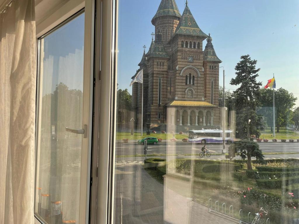 a view of a church from a window at ELENA Center Apartment in Timişoara