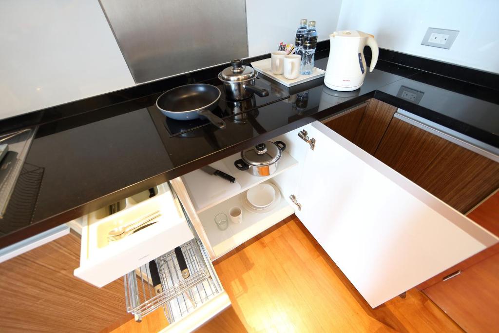 A compact fitted kitchen with an induction hob, oven and countertop appliances.