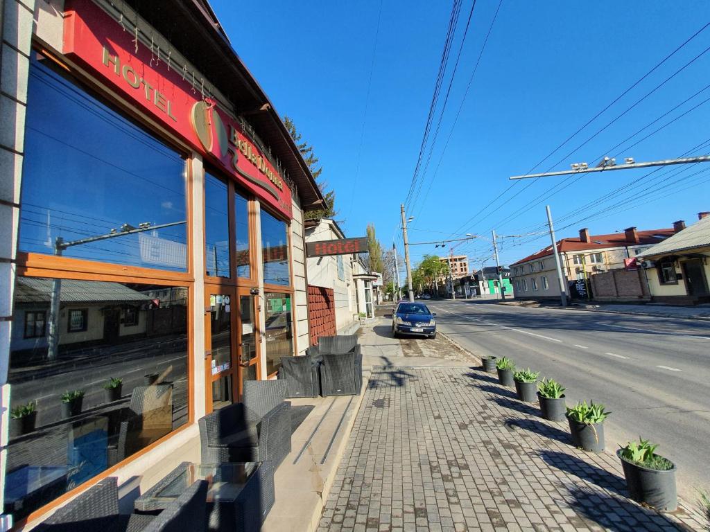 a car parked in front of a building on a street at Bella Donna Hotel in Chişinău