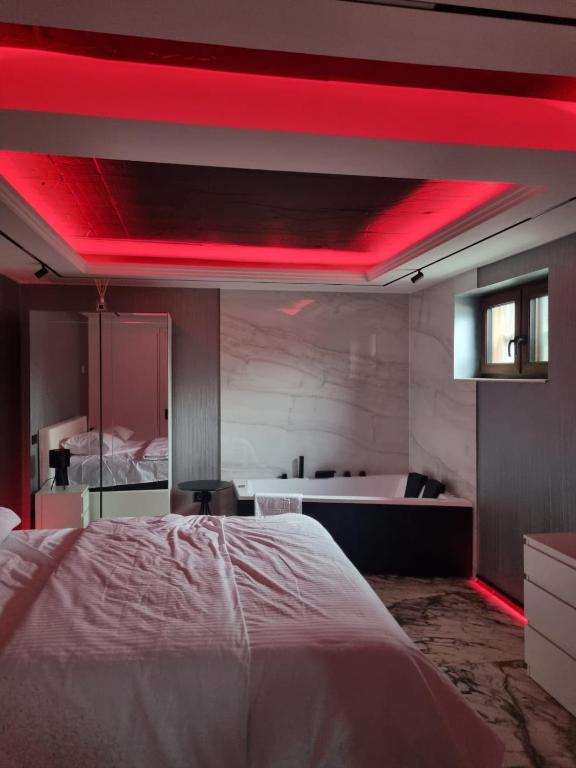 a bedroom with a white bed and a red ceiling at ApuLux Apartments in Alba Iulia