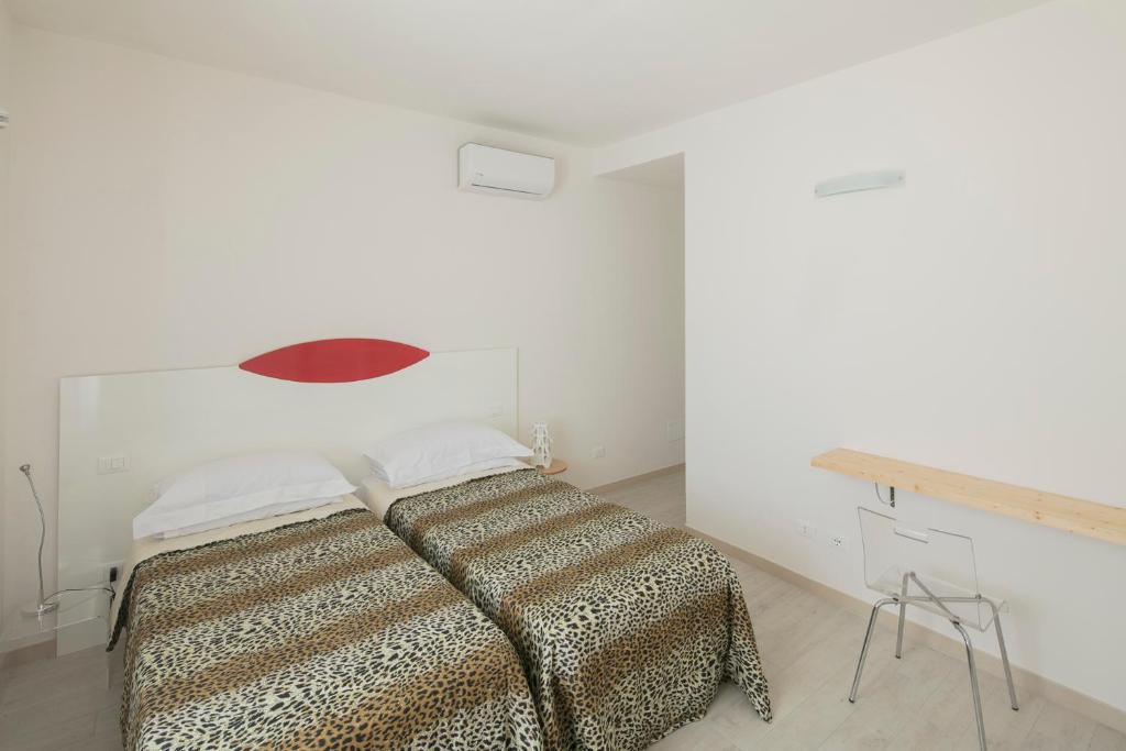 A bed or beds in a room at Affittacamere Margherita