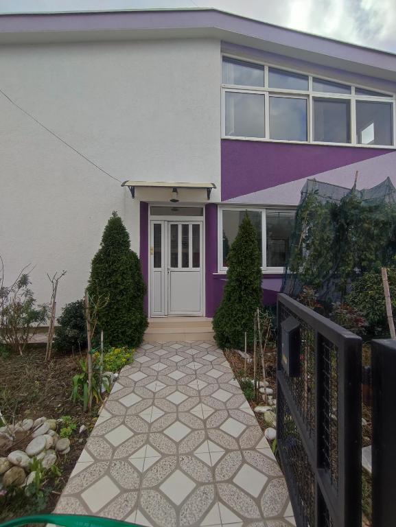 a house with a purple and white house at Bar ,2 sobni stan ,Namaste ! in Bar