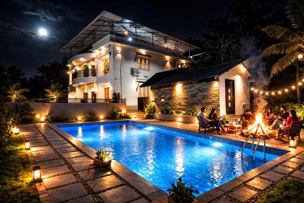 a house with a swimming pool at night at Amara Lux Rivage wynad in Vythiri