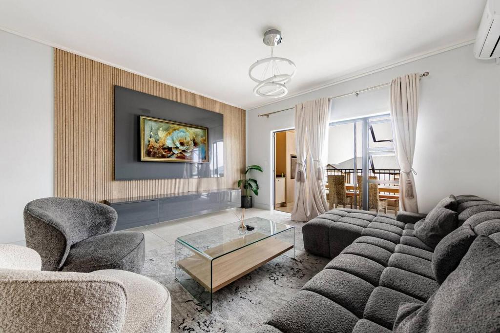 a living room with a couch and chairs and a table at 2 Bedroom 2 Bathroom Executive Suite in Midrand