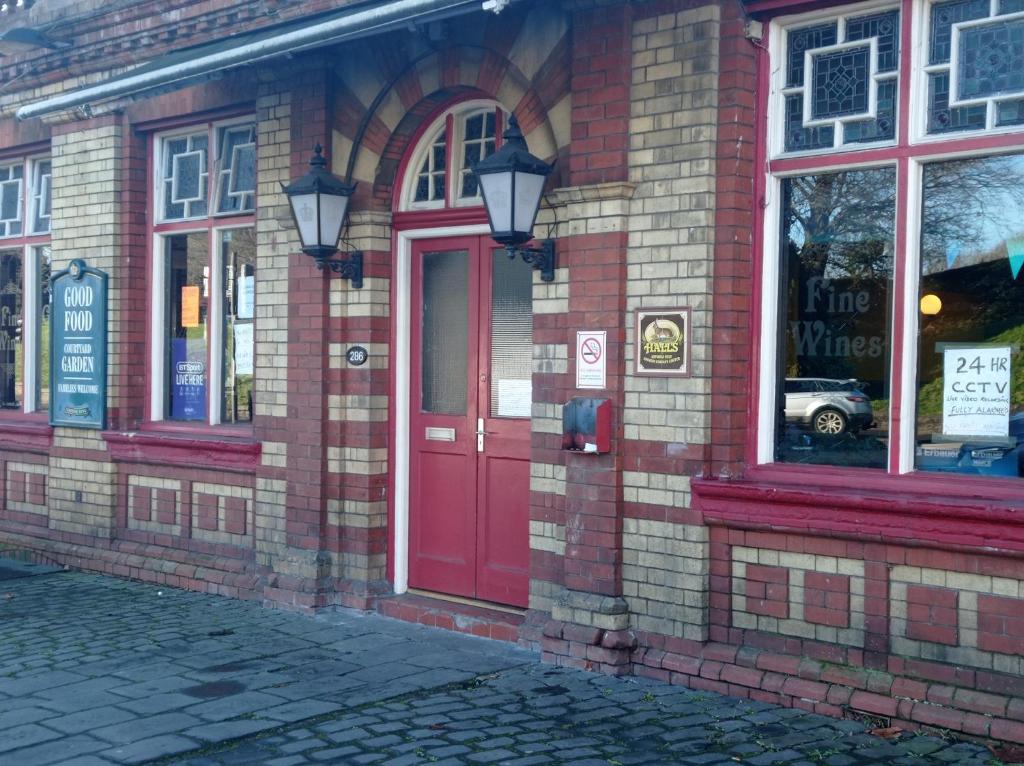 a brick building with a red door on a street at Bristol Hotel in Bristol