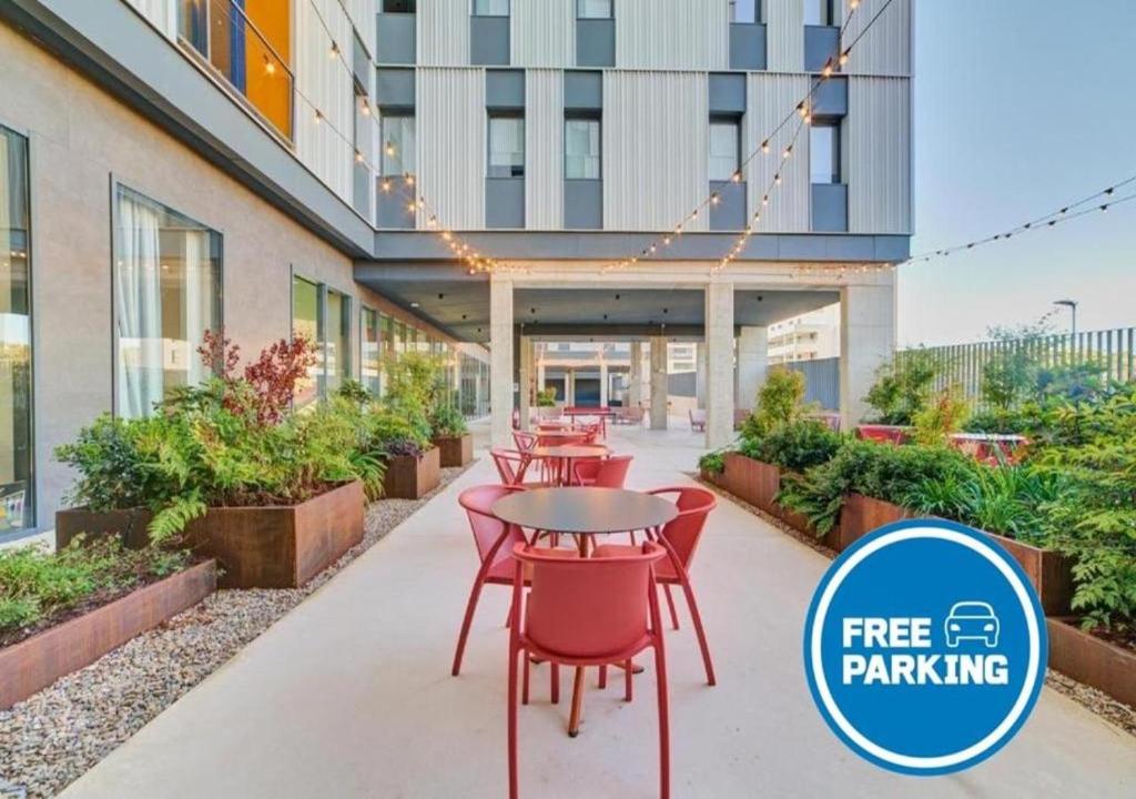 a group of tables and chairs in front of a building at Home and CoLiving Pamplona in Pamplona