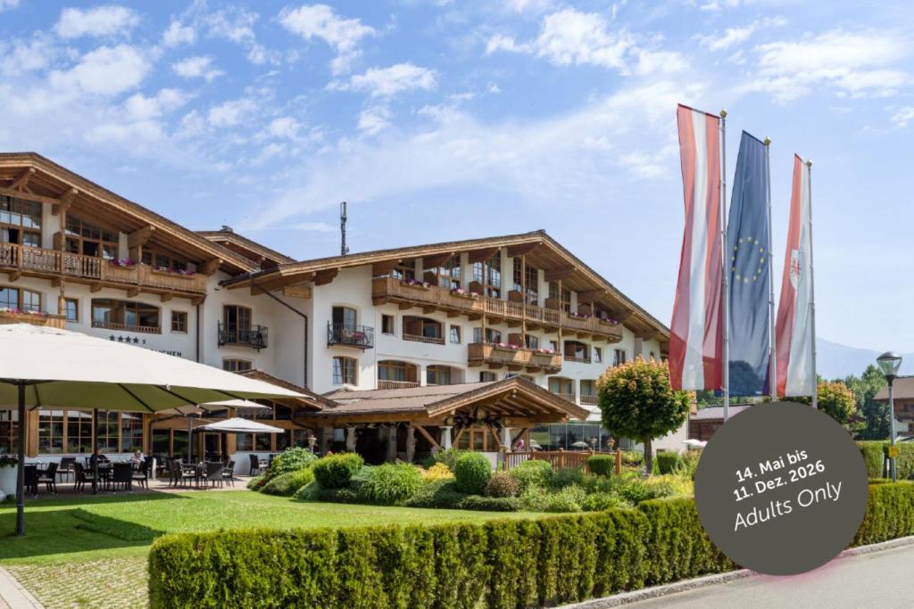 a hotel with a sign in front of it at Hotel & Spa Sonne 4 Sterne Superior in Kirchberg in Tirol