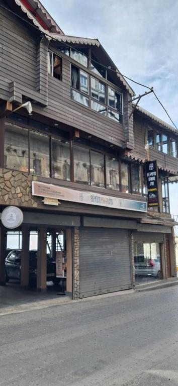 a large building with a store on a street at Beyond Baari Inn in Darjeeling