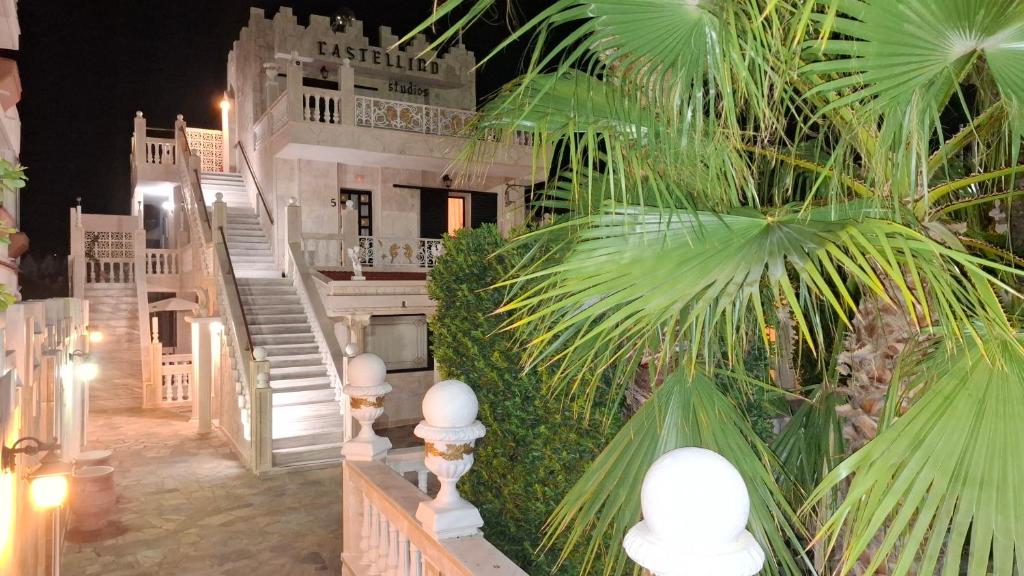 a view of a building with stairs and palm trees at Castellino Studios in Faliraki