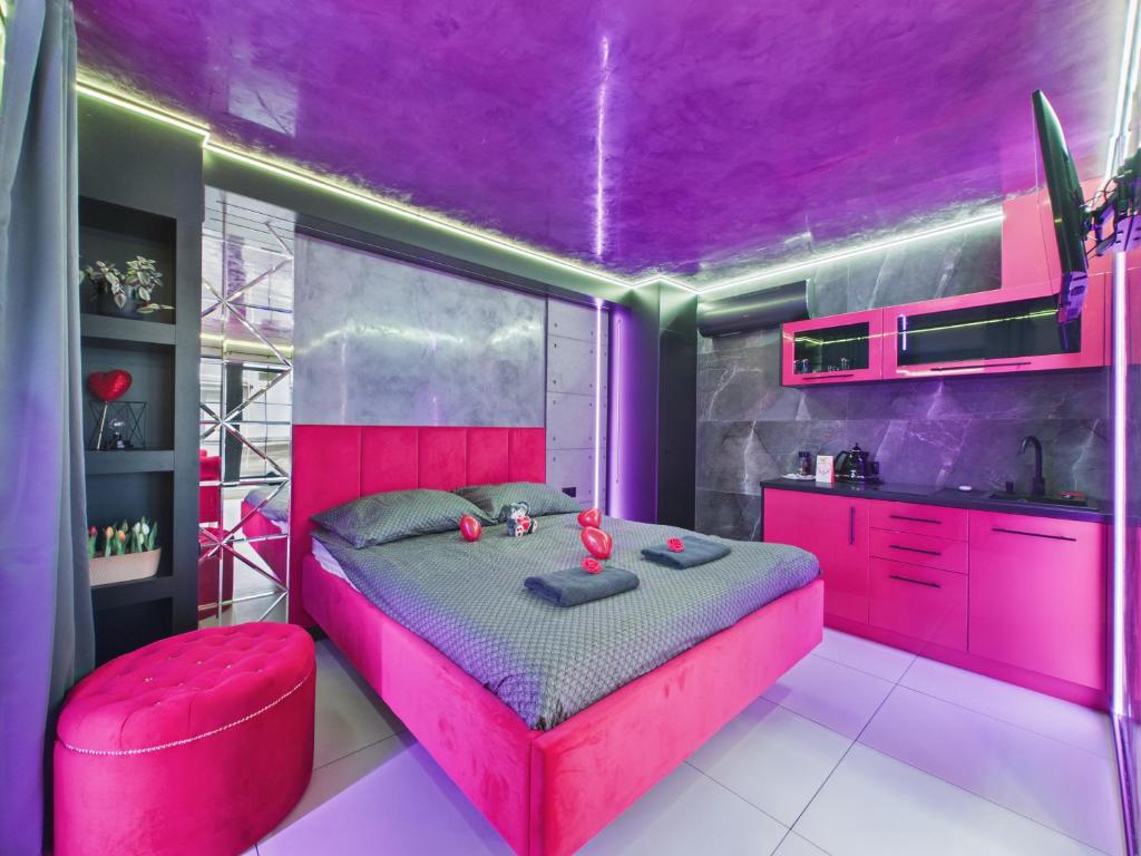 a pink bedroom with a bed and a purple ceiling at LoveAparts Marki Romantic Stay in Marki