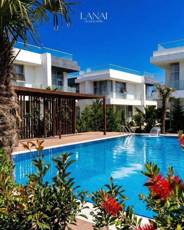 a swimming pool in front of a building at Lanai Villas Beach Side in Baku