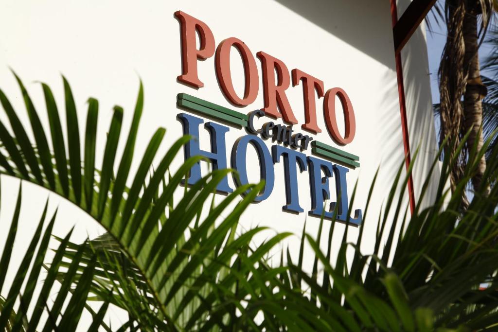 a sign for a roo hotel on the side of a building at Porto Center Hotel in Luís Eduardo Magalhães