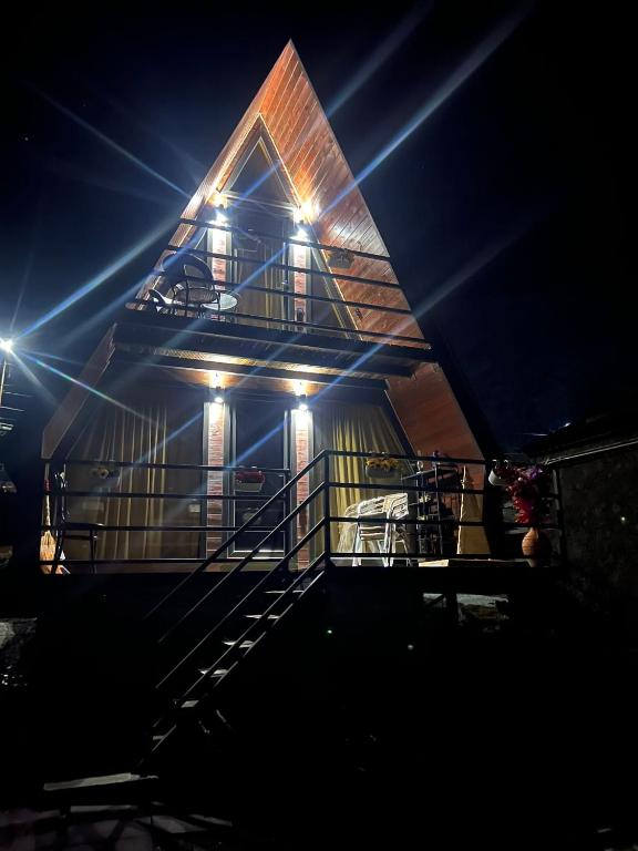 a house with a staircase with lights on it at Zaga Cottage in Kazbegi
