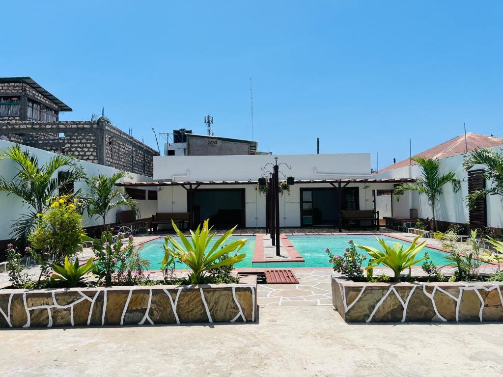a resort with a swimming pool and some plants at Casa Yangu in Watamu