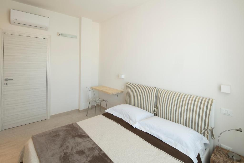 A bed or beds in a room at Affittacamere Margherita