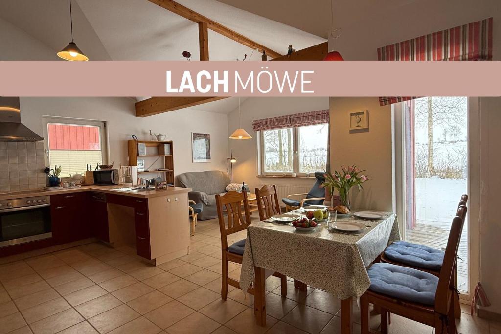 a kitchen and dining room with a table and a light house at Lachmöwe in Munkbrarup