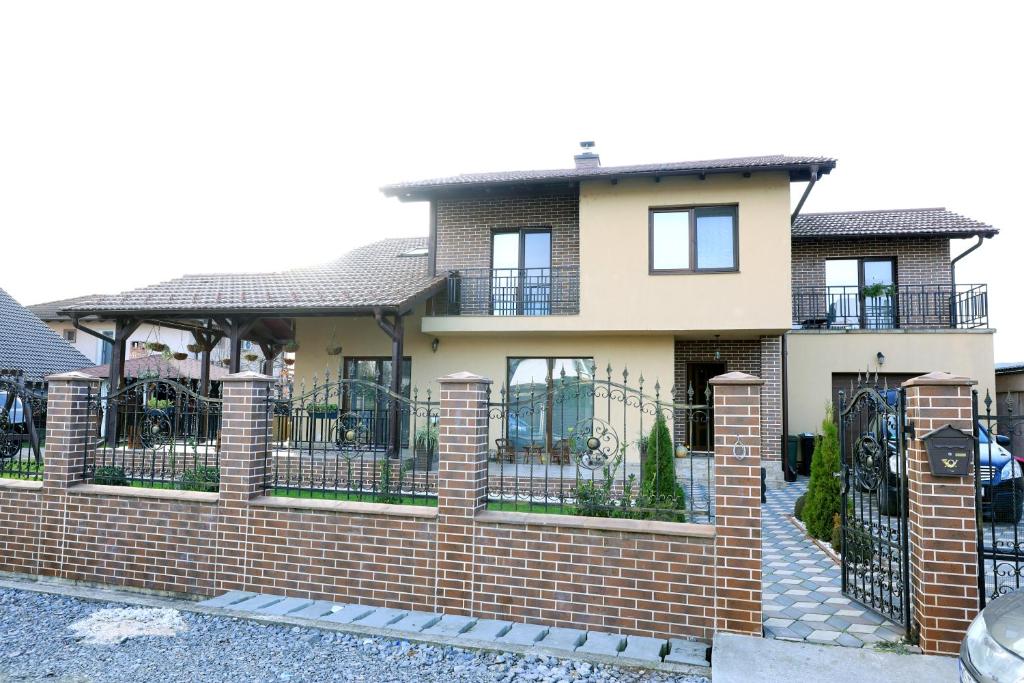 a brick fence in front of a house at Casa Sofia in Livezeni