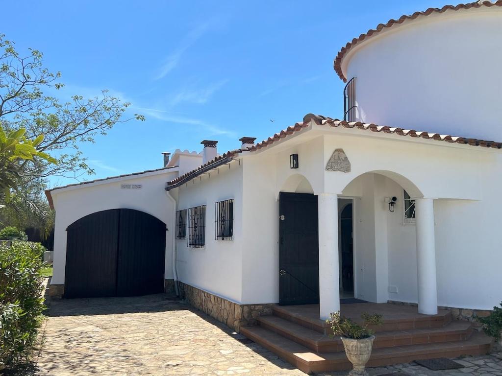 a white house with a black garage at Torre a Sant Martí d'Empúries in L'Escala
