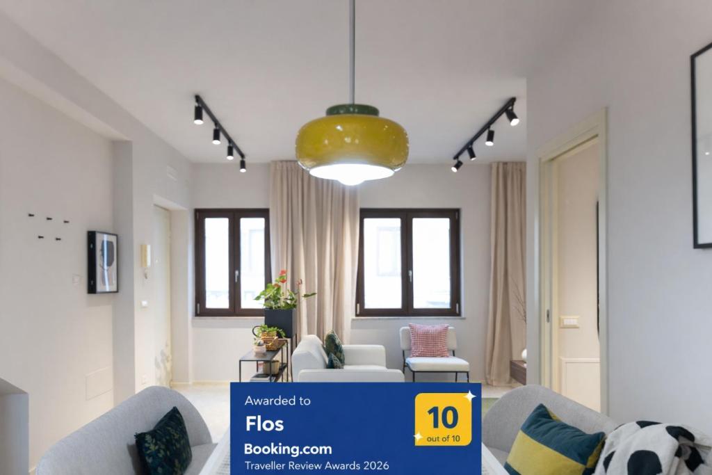a living room with two chairs and a yellow light fixture at Flos in Cassino