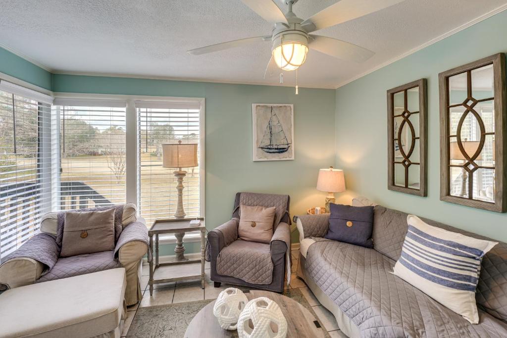 a living room with two couches and a ceiling fan at Golf Course Views! Couple's Retreat in Diamondhead in Diamondhead