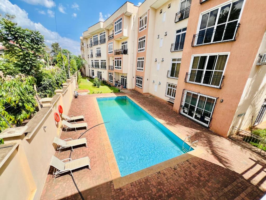 an overhead view of a swimming pool in an apartment building at JJ Comfort Homes in Arusha