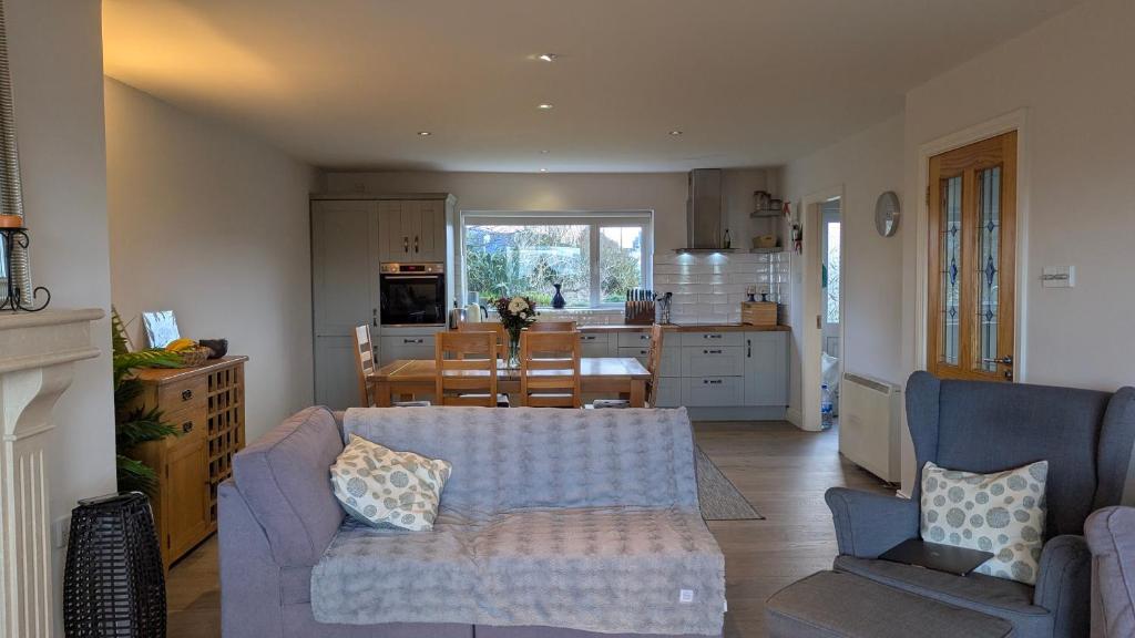 a living room with a couch and a kitchen at Waterville Links in Waterville