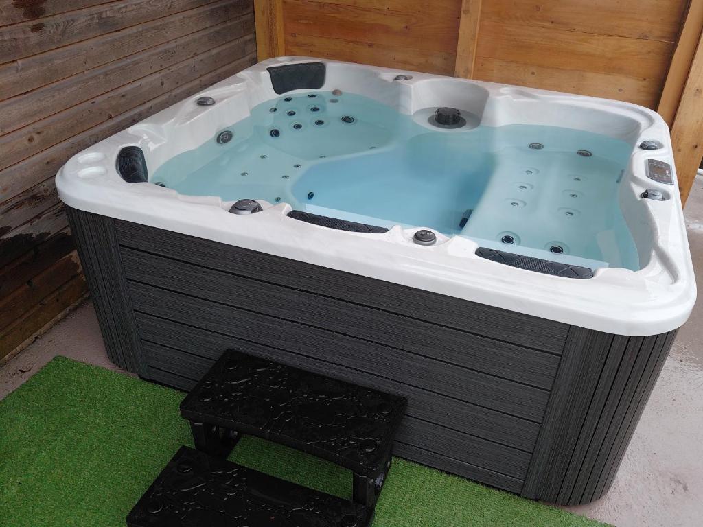 a jacuzzi tub in a room with green at JACUZZI PRIVE Romann 1 in Xonrupt-Longemer