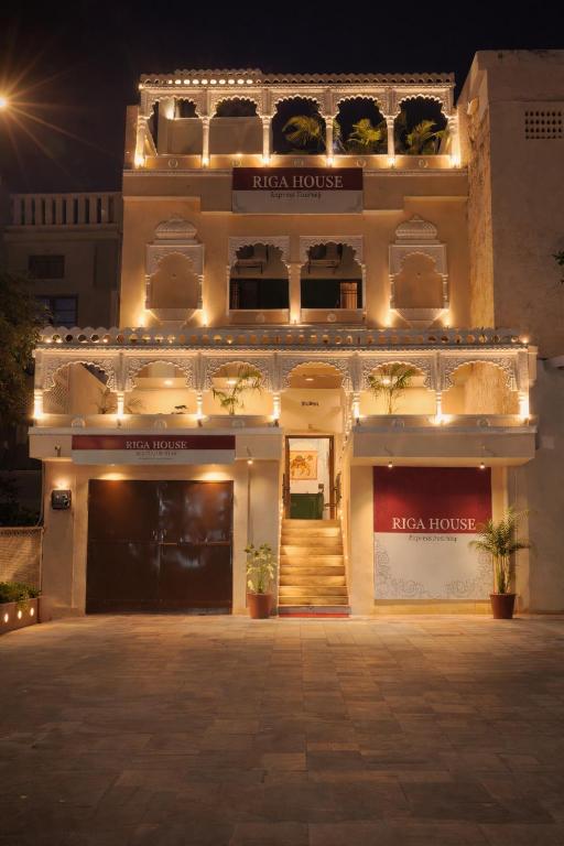 a large building with lights in front of it at Riga House in Udaipur
