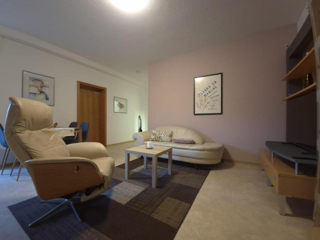 a living room with a couch and a table at Ferienwohnung Annenblick in Sankt Wendel