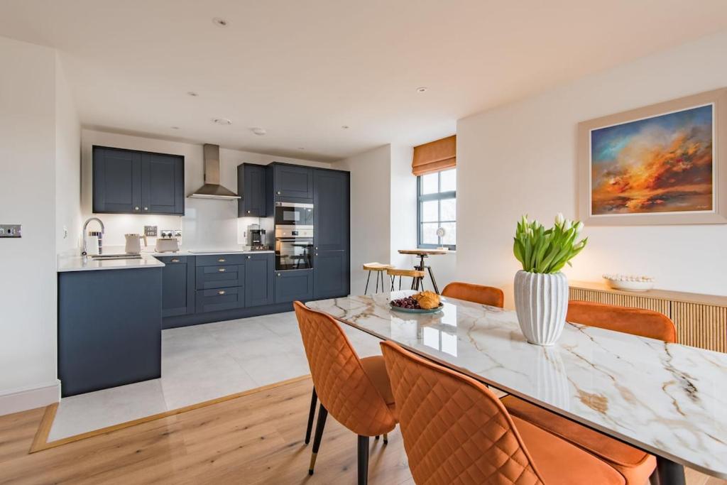 a kitchen and dining room with a table and chairs at iDeal Apartment by Keepers Cottages in Deal