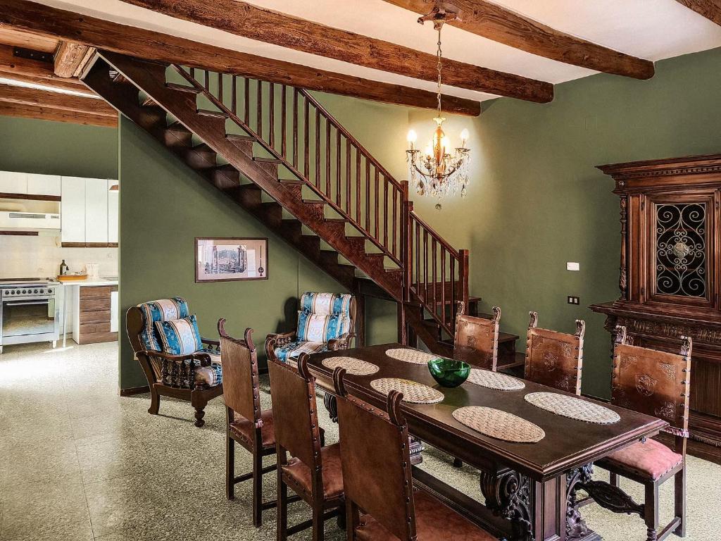 a dining room with a table and a staircase at I Segreti del Borgo - Cosmopolitan in Ostra
