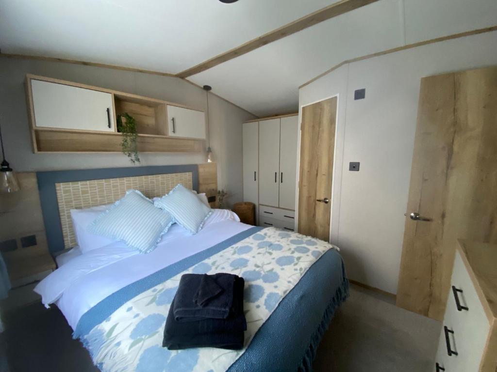 a bedroom with a large bed with a backpack on it at Sheepfold lodge in Sedbergh