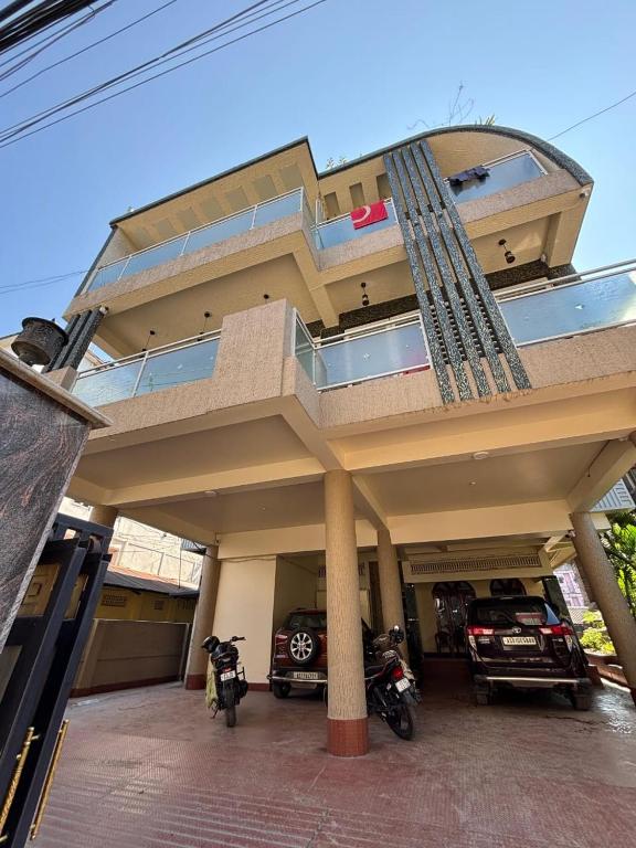 a large building with motorcycles parked in front of it at Nibha Homestay Near Guwahati Railway station 2BHK in Guwahati