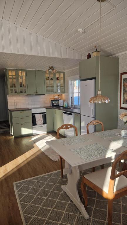 a kitchen with a table and chairs in a room at Säbytorp in Kil