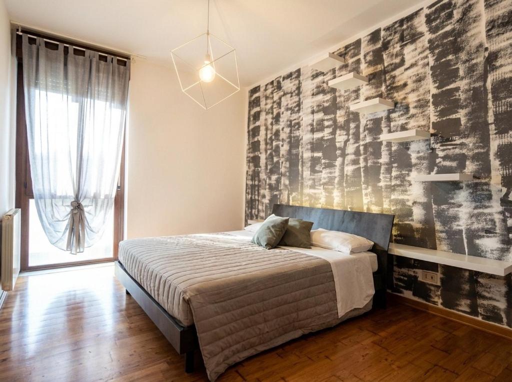 a bedroom with a bed and a large wall at hotel al palazat in Cavasso Nuovo