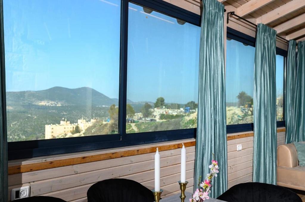 a room with large windows with a view at Even Vanof - אבן ונוף in Safed