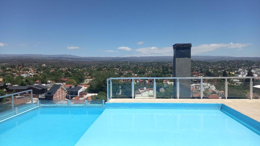 a swimming pool with a view of a city at Carcano Temporarios in Villa Carlos Paz