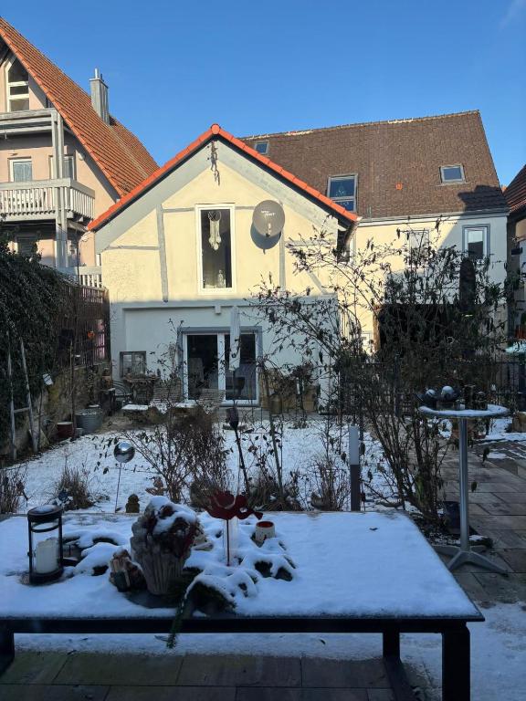 a house covered in snow with a table in front of it at Idyllisches Kleinod in Gerolzhofen