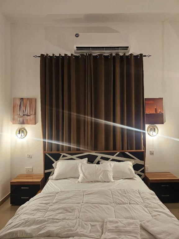 a bedroom with a large bed with two night stands at Big studio in Jimi Alain city in Al Ain