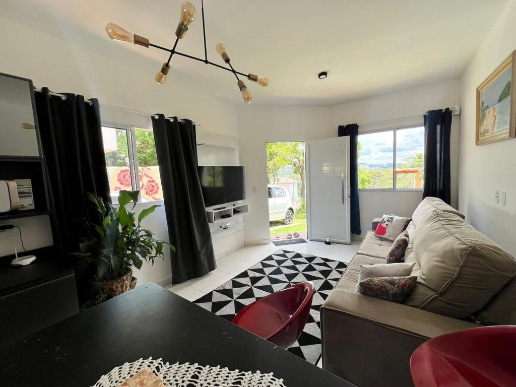 a living room with a couch and a table at Casa com Piscina em Jarinu in Jarinu