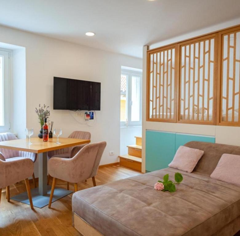 a living room with a couch and a table at Blue Bay Apartment Piran in Piran
