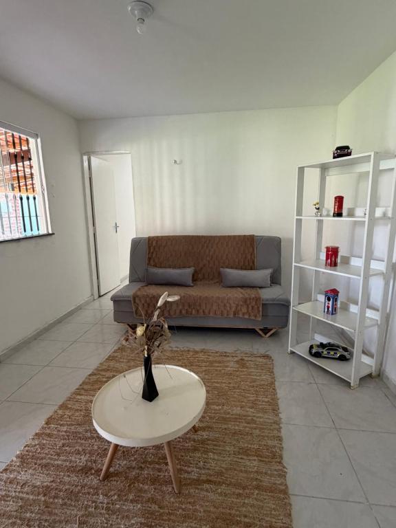 a living room with a couch and a table at Sweet home in São Luís