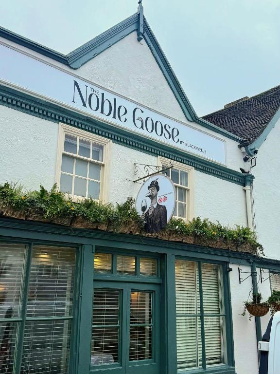 a building with a sign that reads noble goose at Noble Goose Rooms in Coggeshall