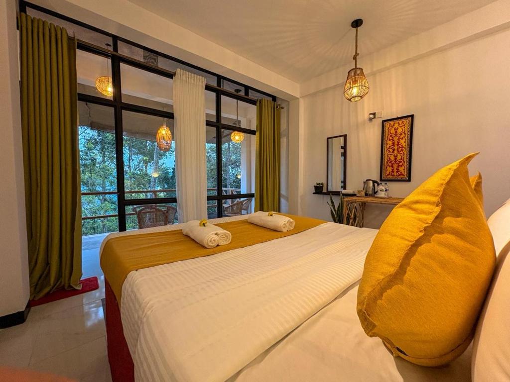 a bedroom with two beds and a large window at Tea Ridge Ella by SANS in Ella