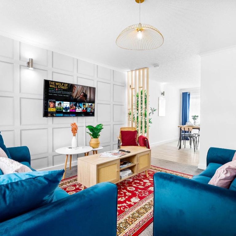 a living room with blue chairs and a tv at Stylish 3 Bedroom House - King Size Beds - 5 Guests - Garden & Parking 4VC in Minworth