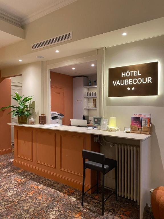 a hotel lobby with a hotel vancouver sign on the wall at Hôtel Vaubecour - Centre Lyon Ainay - Perrache in Lyon